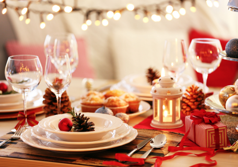 Wine glasses and dinnerware on Christmas table