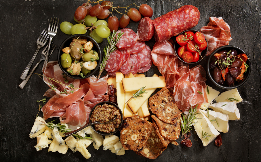 charcuterie board with cured meat, cheese and olives