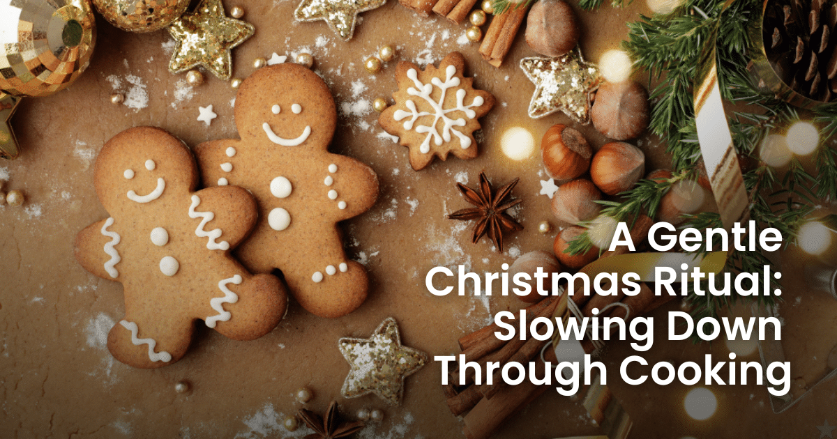 Two Christmas gingerbread-style biscuits shaped like people, surrounded by pine branches and festive decorations in warm, cosy tones.